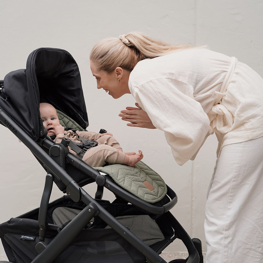 Mother Smiling at baby in buggy